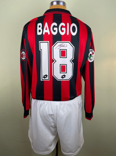 A short-sleeved AC Milan football jersey with the name 'Baggio' and the number '18' on the back, signed by Roberto Baggio.