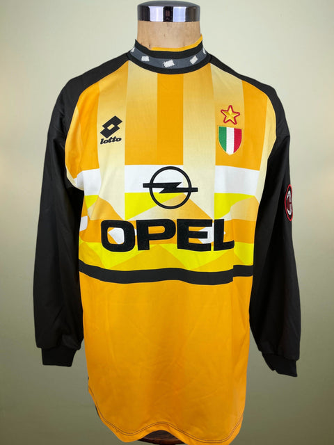 Yellow and black AC Milan jersey with Opel logo on a mannequin against a neutral background