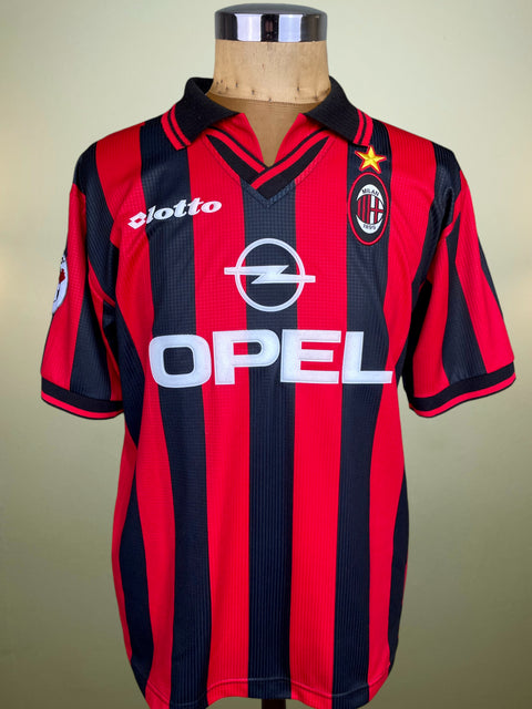 Red and black striped sports jersey with Opel logo on a mannequin against a plain background