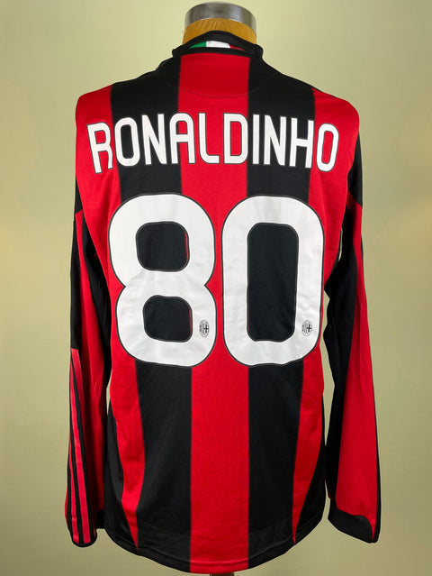 A short-sleeved AC Milan jersey with red and black stripes, featuring the name 'RONALDINHO' and the number '80' on the back.