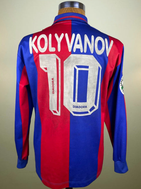 A long-sleeved Bologna 1996-97 home jersey with a name and number on the back, predominantly red with blue and white accents, and the crest of a football club.