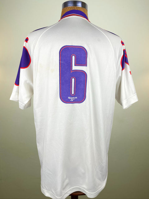 White Fiorentina jersey with number 6 on a mannequin against a neutral background