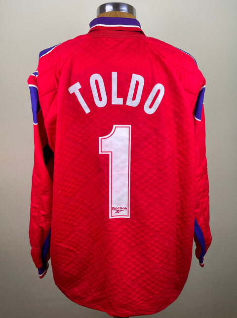 A red Fiorentina 1995-96 Goalkeeper jersey with white number 1 on the back and the name 'TOLDO' across the chest, featuring blue and white accents on the sleeves.