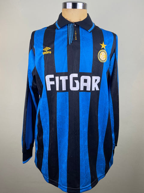 Beppe Bergomi's Match Worn Inter Milan 1991-92 long-sleeved soccer jersey with blue and black stripes, featuring the Inter logo on the chest and the sponsor 'FITIGAR' on the front. The jersey is displayed on a mannequin.