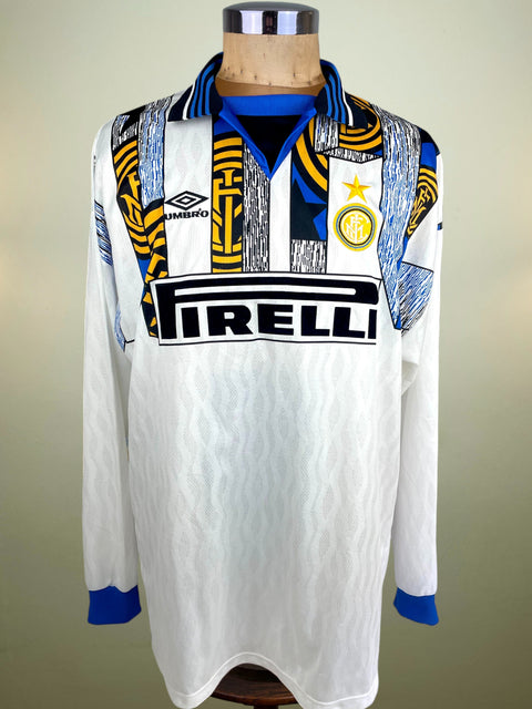 Inter away shirt in white from 1995/96, worn by Roberto Carlos. Long-sleeve Umbro issue with Pirelli sponsor, finished with ROBERTO CARLOS 6 in official flock.
