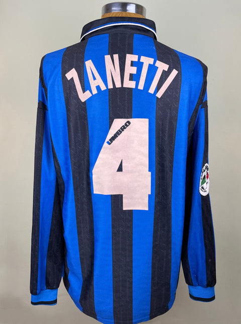 A blue match worn Inter Milan Home jersey from the 1996-97 with the number 4 and the name ZANETTI on the back, with a V-neck collar.