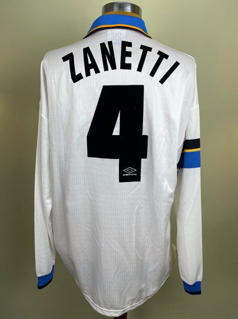 A white Inter Milan Match worn 1997-98 away soccer jersey with the name 'Zanetti' and the number '4' on the back in flock numbering, with a blue and black trim.