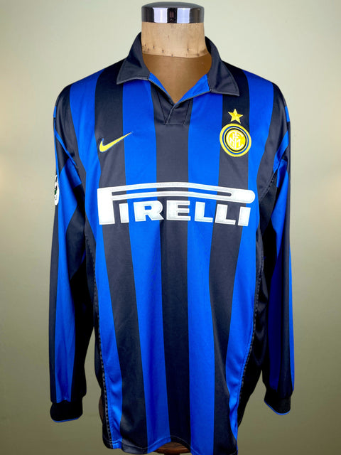 Blue and black striped Inter Milan 1998 jersey with Pirelli and Nike logos on a mannequin against a beige background