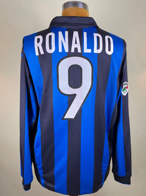 Ronaldo's match worn long-sleeved Inter Milan 1998-99 Soccer jersey with a V-neck, predominantly blue with black accents, and the name 'RONALDO' and the number '9' printed on the back in light plastic.