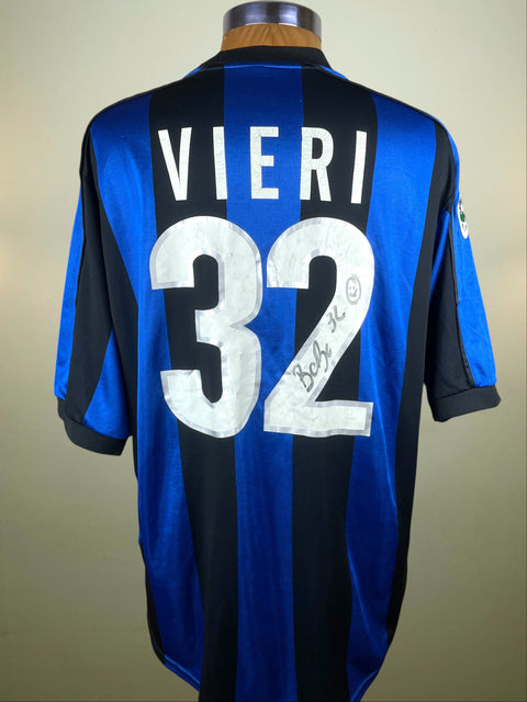 Blue and black Inter Milan 1999-00 jersey with 'Vieri 32' printed on a mannequin against a beige background