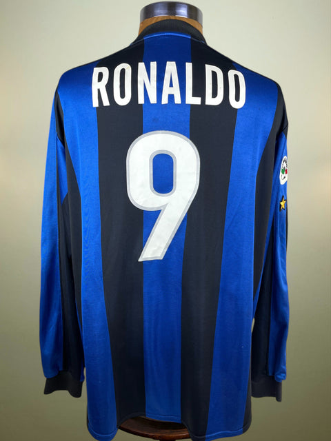 Blue match worn Inter Milan 1999-00 home jersey with 'RONALDO' and number '9' on a mannequin against a beige background