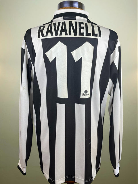 Black and white striped Juventsu 1995-96 jersey with 'Ravanelli' and number '11' on the back in light plastic on a mannequin against a neutral background