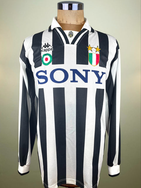 Black and white striped Juventus jersey with Kappa and Sony logos on a mannequin against a neutral background