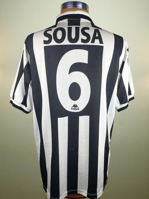 Black and white Juventus striped sports jersey with 'Sousa' and number '6' on a mannequin against a neutral background