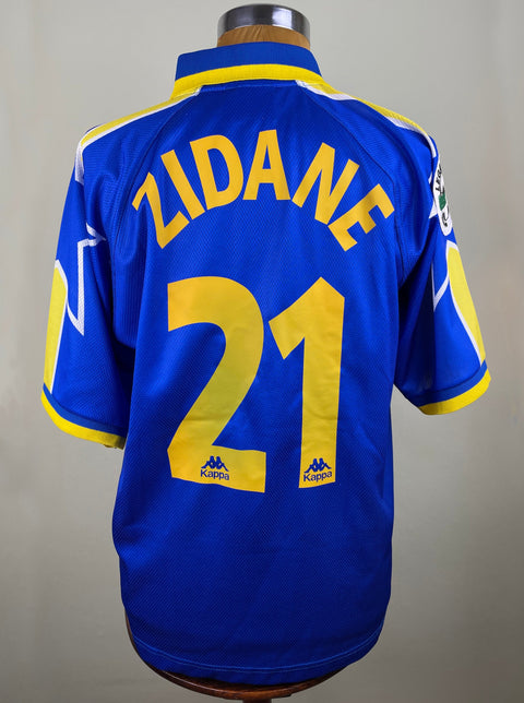 A blue Juventus 1996-97 match worn jersey with the number 21 and the name ZIDANE on the back in yellow and white text.