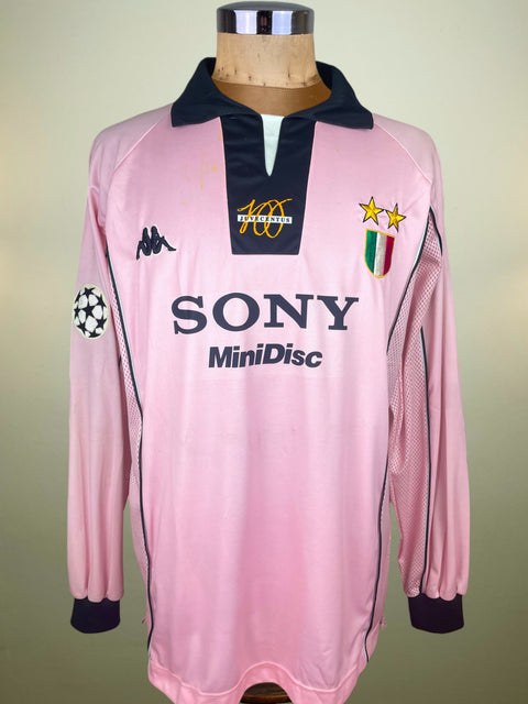 Pink Juventus Centenary match prepared Zinedine Zidane jersey with Sony Minidisc Sponsor on the chest and the Champions League patch on the arm. On a mannequin against a beige background