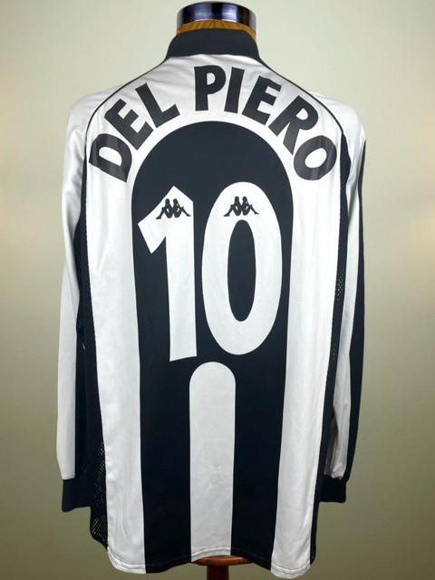 A black and white striped Juventus match worn home jersey in long sleeves with the name 'DEL PIERO' and the number '10' on the back, displayed on a mannequin.