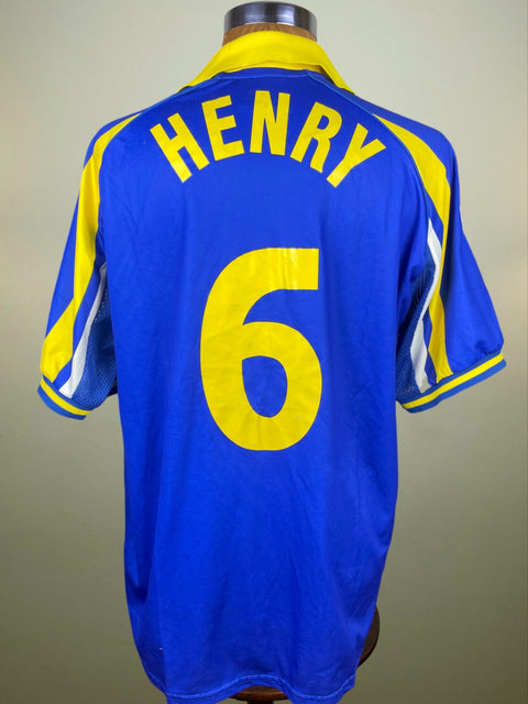 Blue match worn Thierry Henry Juventus 1998-99 Away jersey with yellow accents and 'HENRY 6' printed in yellow plastic on a mannequin against a neutral background