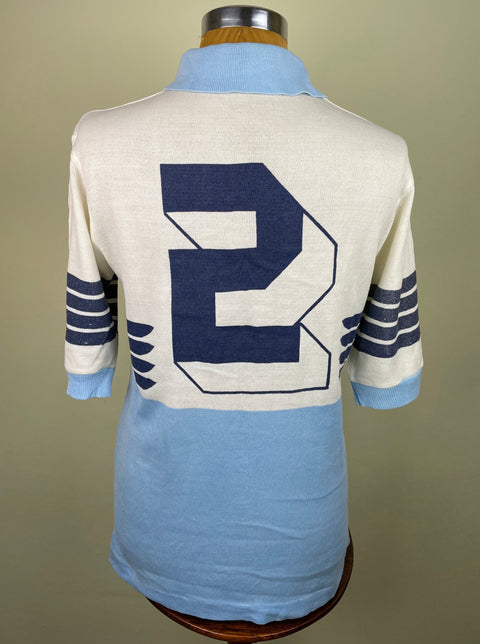 A vintage Lazio match prepared 1982 home jersey displayed on a mannequin, primarily white with blue and black accents made by Ennerre NR with number 2 painted on the back.