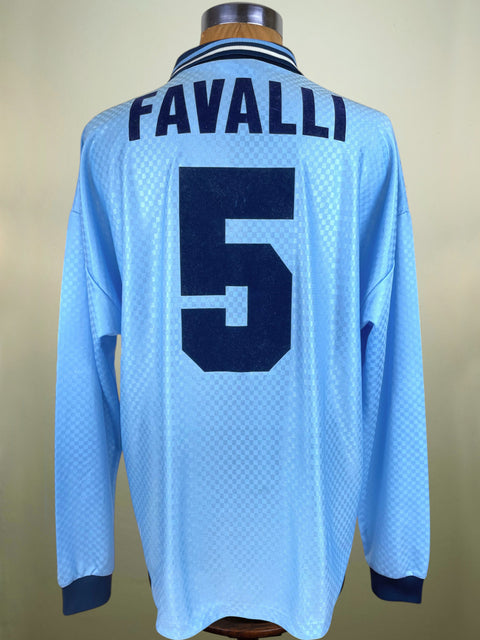 Light blue Lazio 1995-96 jersey with 'FAVALLI' and number '5' on a mannequin against a beige background