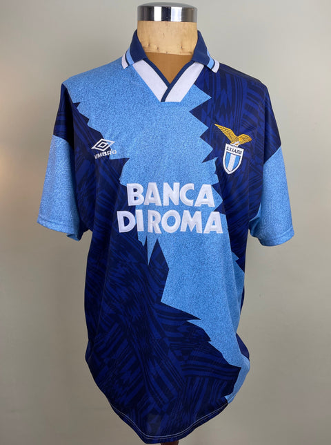 Match worn blue short sleeve Lazio third shirt from the 1995-96 season worn by Beppe Signori with Banca di Roma Sponsor in white flock across the front of the shirt. Made by Umbro.