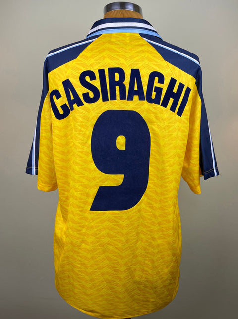 Match worn yellow short sleeve Lazio away shirt from the 1996-97 season worn by Pierluigi Casiraghi with name and number 9 in black flock across the front of the shirt. Made by Umbro.