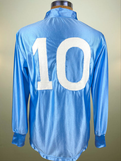 Blue Napoli 1988-89 jersey with Diego Maradona's number 10 on a mannequin against a beige background
