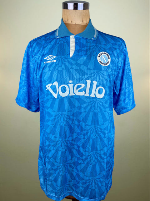Blue Napoli 1992-93 Umbro jersey with Voiello Sponsor on a mannequin against a beige background