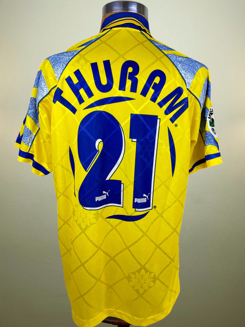 Yellow Parma 1996-97 match worn jersey with 'THURAM 21' printed on a mannequin against a plain background