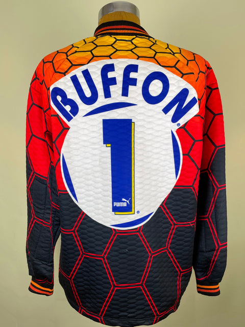 A Puma soccer jersey with a distinctive honeycomb pattern, shown from the back on a mannequin. The design features a red and orange gradient top section, a dark navy bottom section, and a large white circular back patch with 'BUFFON' and the number '1' in blue.