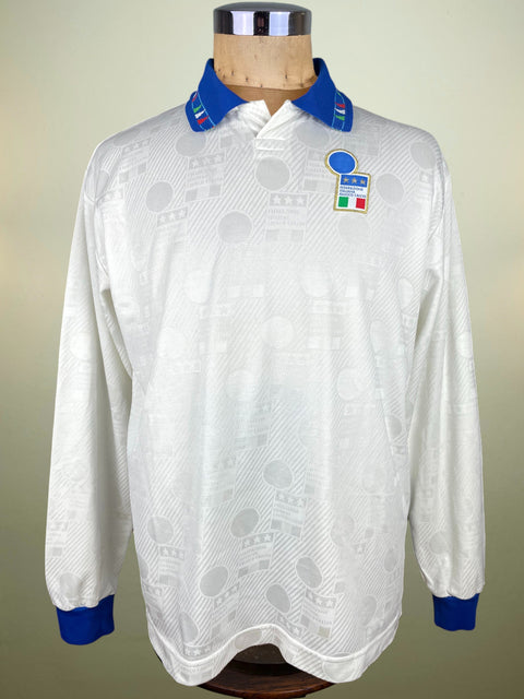 White Italy Away jersey worn by Antonio Benarrivo vs Estonia with blue accents on a mannequin against a neutral background. Missing the Diadora logo on the chest which was banned by the Italian Football Federation on Match shirts