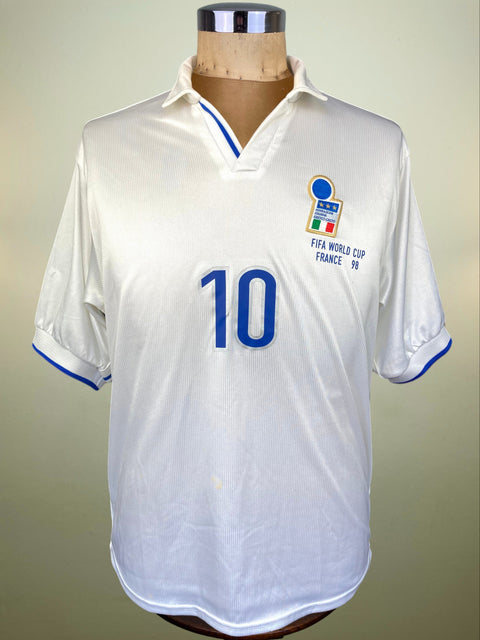 White Italy World Cup 98 jersey with blue numbering and text on a mannequin against a neutral background