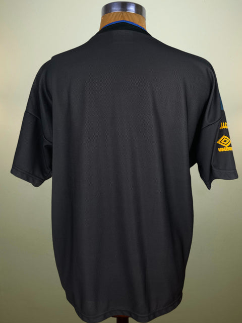 Black Inter Milan Training Shirt from the 94-95 season on a mannequin with a visible brand logo against a beige background