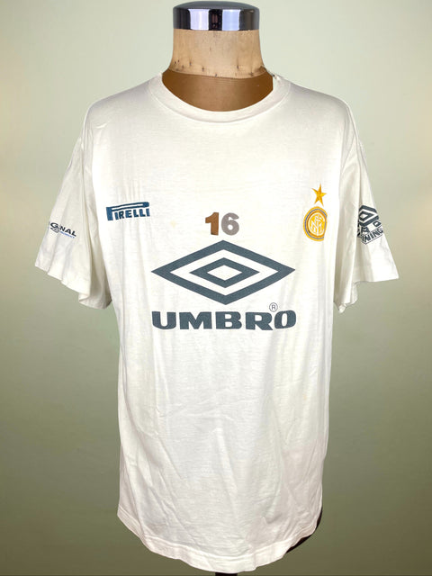 White sports jersey with various logos on a mannequin against a plain background