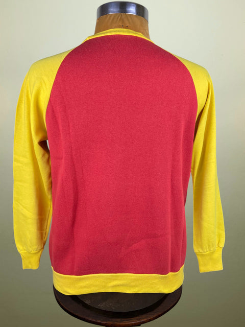 Red and yellow long-sleeve Roma Training shirt on a mannequin against a beige background