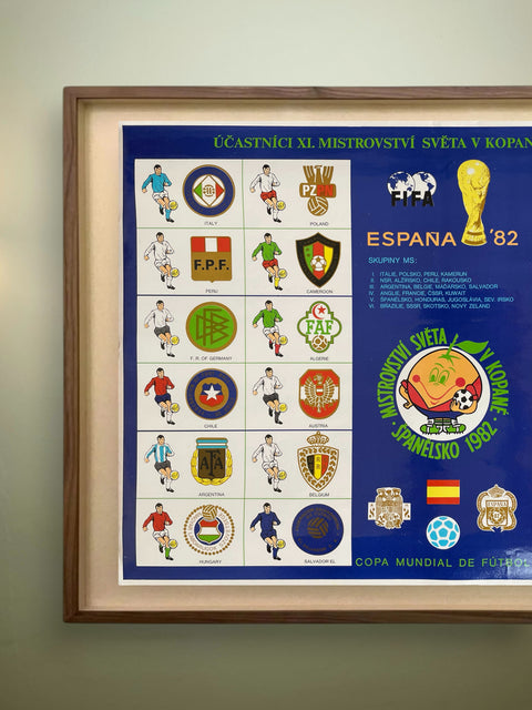 Framed poster of World Cup 1982 participants with team logos on a blue background.