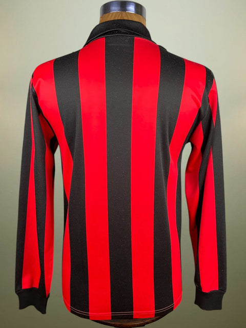 Mannequin wearing a red and black AC Milan striped shirt.
