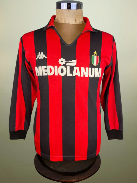 Red and black striped AC Milan 1988 home jersey on a mannequin against a plain background