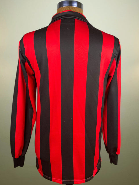 Red and black striped shirt on a mannequin against a neutral background