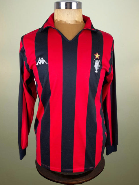 A red and black striped AC Milan soccer jersey from the 1989 Intercontinental Cup, displayed on a mannequin.