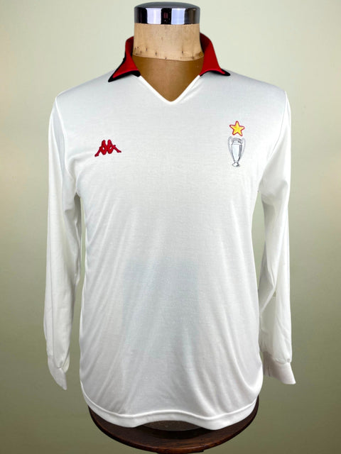 A white AC Milan soccer jersey from 1989 with long sleeves, featuring the Intercontinental Cup logo and the Kappa brand logo.