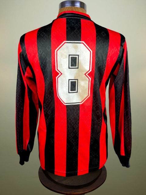 Red and black striped AC Milan 1989 jersey with number 8 on a mannequin against a beige background