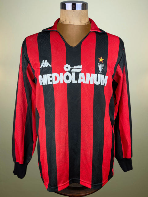 Red and black AC Milan 1989 Home jersey with Mediolanum logo on a mannequin against a neutral background