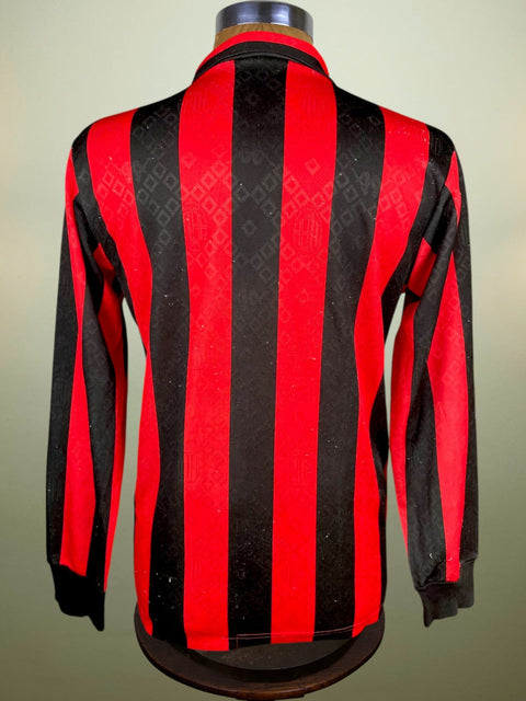 Red and black striped 1989 AC Milan long sleeve soccer jersey on a mannequin against a neutral background