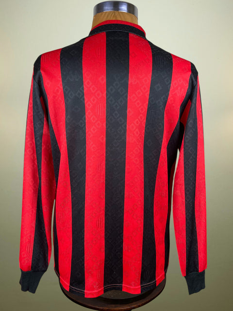 Red and black AC Milan 1989 shirt on a mannequin against a beige background
