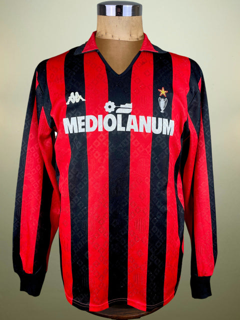 Red and black striped AC Milan 1989 jersey with 'Mediolanum' branding made by Kappa on a mannequin against a beige background.
