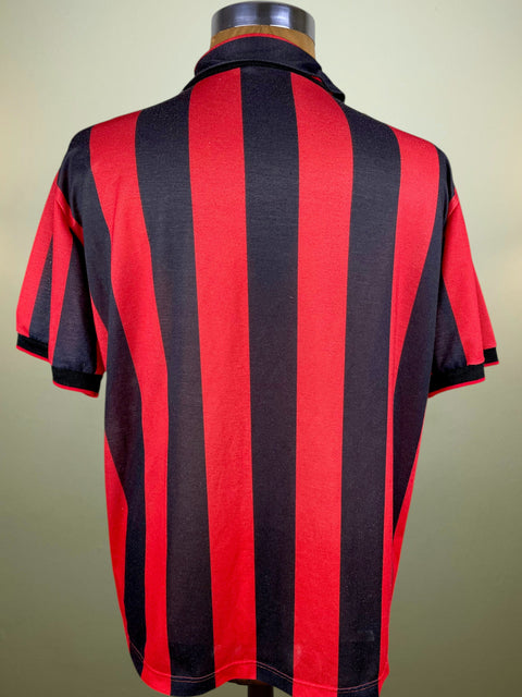 Red and black striped shirt on a mannequin against a beige background
