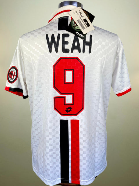 White AC Milan soccer jersey with 'WEAH' and number 9 on the back, featuring red and black accents, displayed on a mannequin.