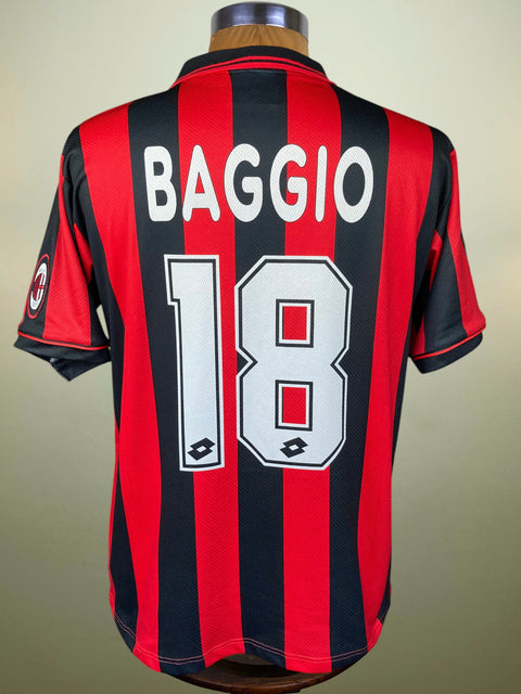 AC Milan vintage home jersey with red and black vertical stripes, featuring 'BAGGIO' and the number '18' on the back, displayed on a mannequin.