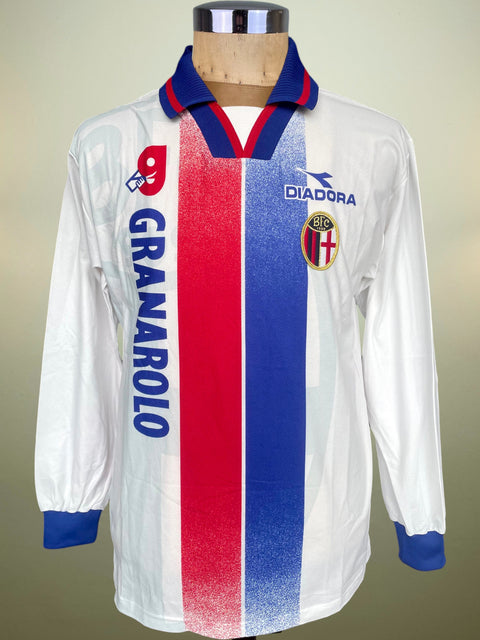 A vintage long-sleeve Diadora soccer jersey for the club Granarolo, displayed on a wooden mannequin torso. The jersey is white with bold vertical red and blue stripes down the center, a blue and red V-neck collar, and blue cuffs.